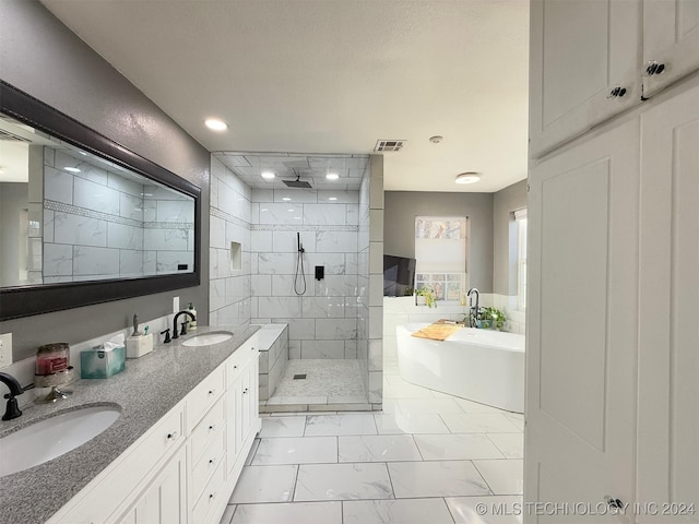 bathroom featuring vanity and shower with separate bathtub