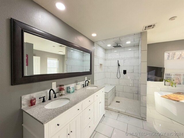 bathroom with vanity and a tile shower