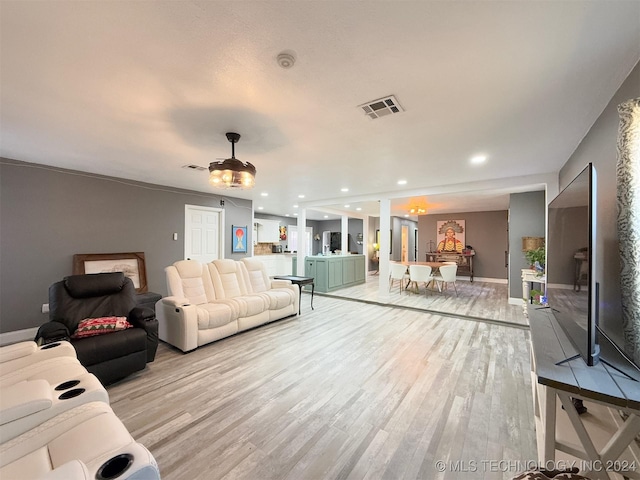 living room with light hardwood / wood-style flooring and an inviting chandelier