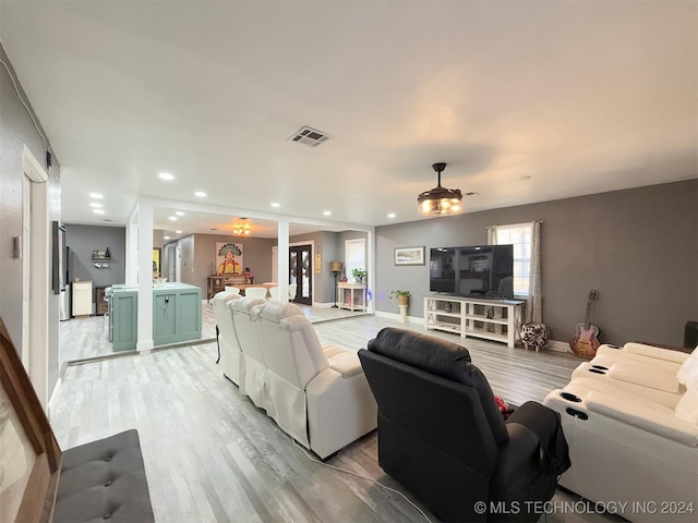 living room with light wood-type flooring and ceiling fan