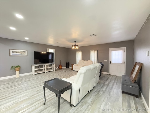 living room featuring light wood-type flooring and a wealth of natural light