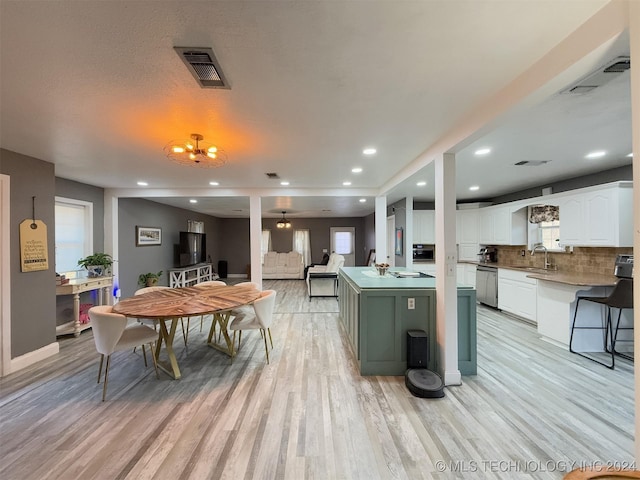 dining area featuring sink and light hardwood / wood-style floors