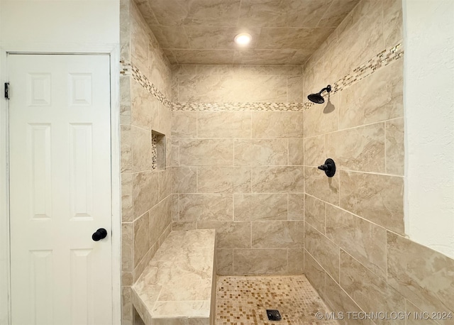 bathroom with a tile shower