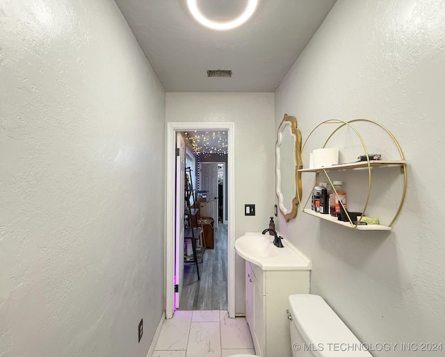 bathroom with vanity and toilet