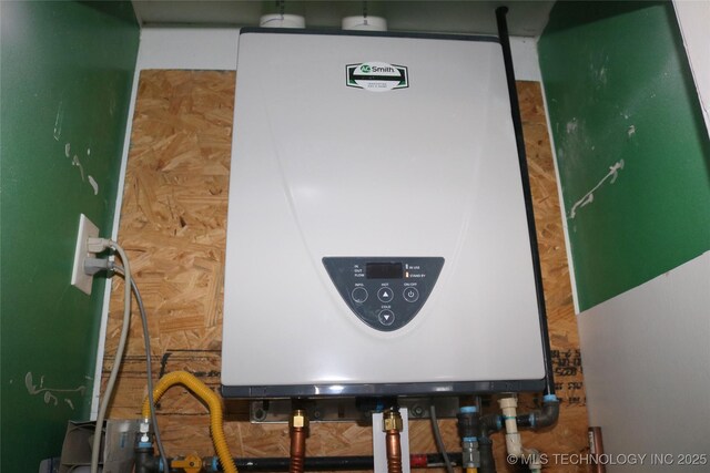 utility room featuring water heater