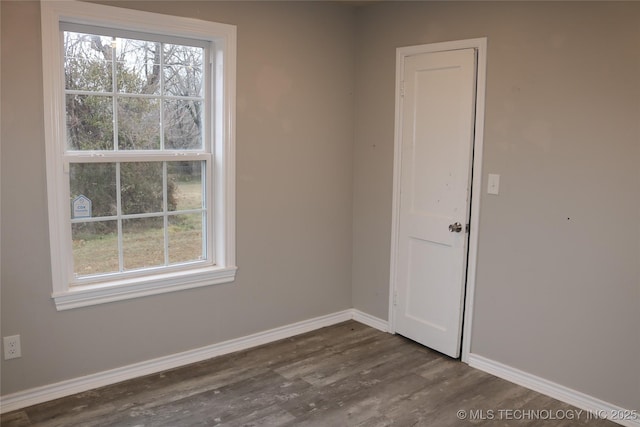 spare room with dark hardwood / wood-style floors