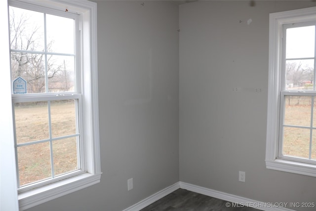 unfurnished room with dark wood-type flooring