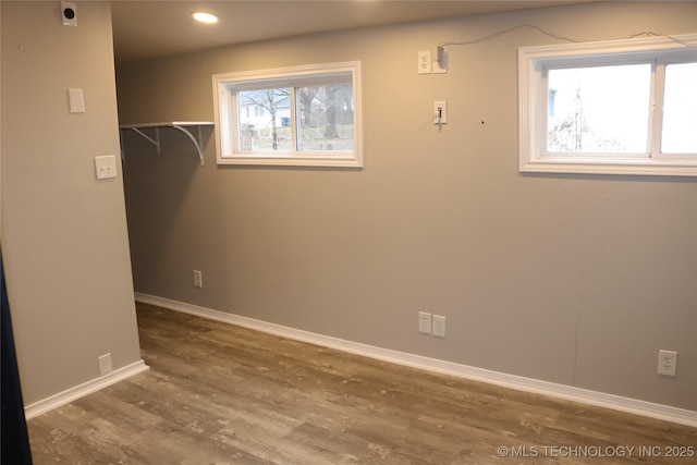 clothes washing area featuring hardwood / wood-style flooring