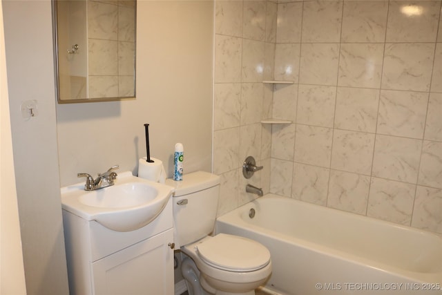 full bathroom with vanity, tiled shower / bath, and toilet