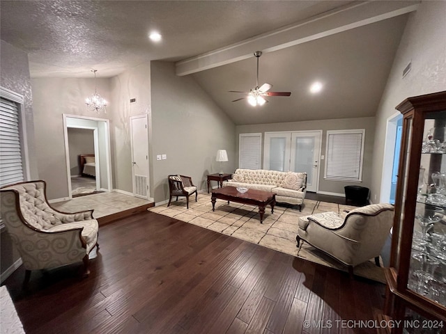 living room featuring beamed ceiling, ceiling fan with notable chandelier, light hardwood / wood-style floors, and a textured ceiling