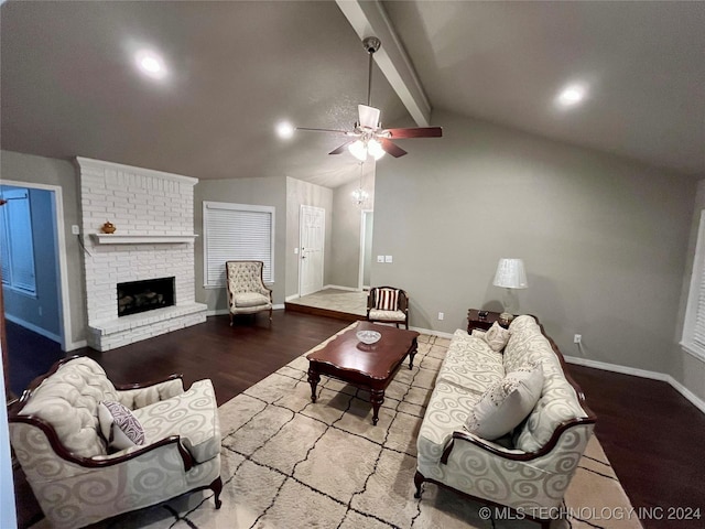 living room with ceiling fan, wood-type flooring, lofted ceiling with beams, and a brick fireplace