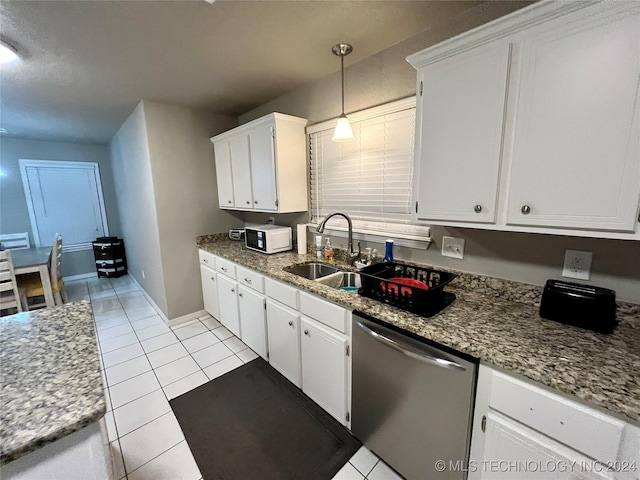 kitchen with stainless steel dishwasher, sink, pendant lighting, white cabinets, and light tile patterned flooring