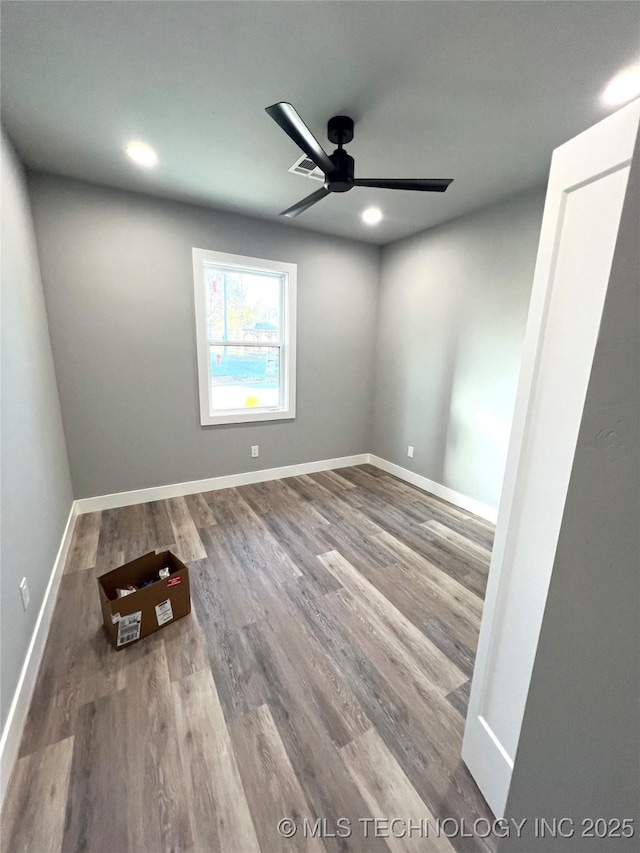 empty room with wood-type flooring and ceiling fan