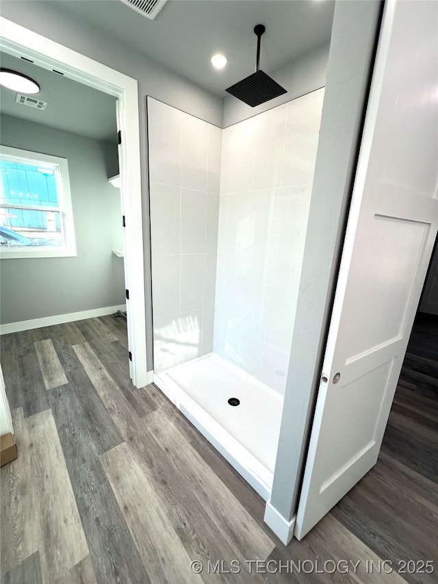 bathroom with hardwood / wood-style floors and walk in shower