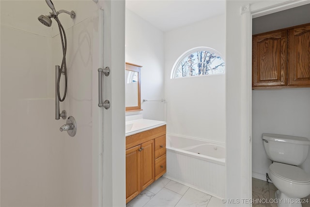 bathroom with vanity, toilet, and tiled tub