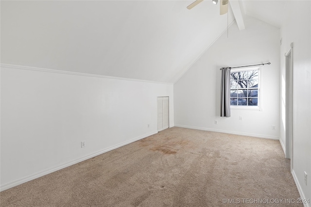 additional living space featuring light carpet and vaulted ceiling with beams