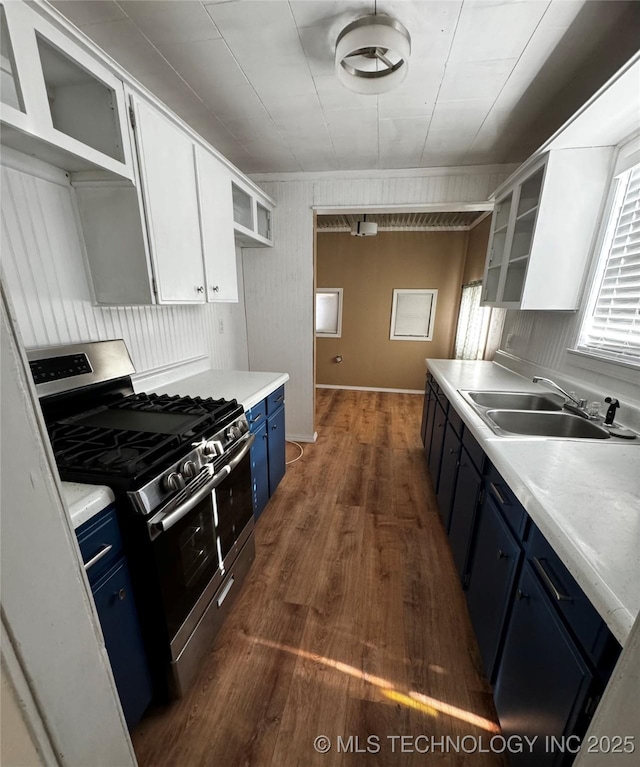 kitchen featuring stainless steel gas stove, dark hardwood / wood-style floors, white cabinets, blue cabinets, and sink