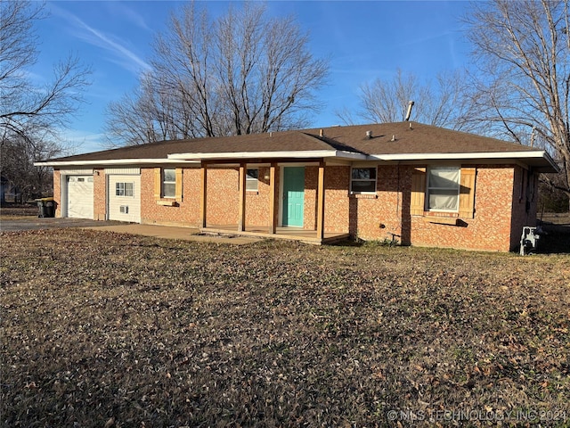 rear view of house featuring a garage