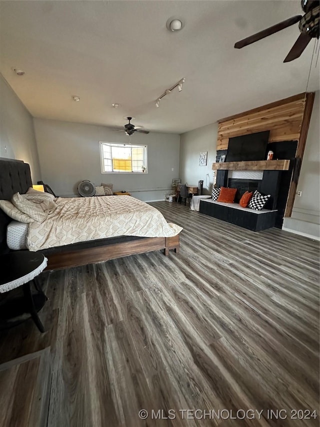 bedroom with ceiling fan, dark hardwood / wood-style flooring, and rail lighting