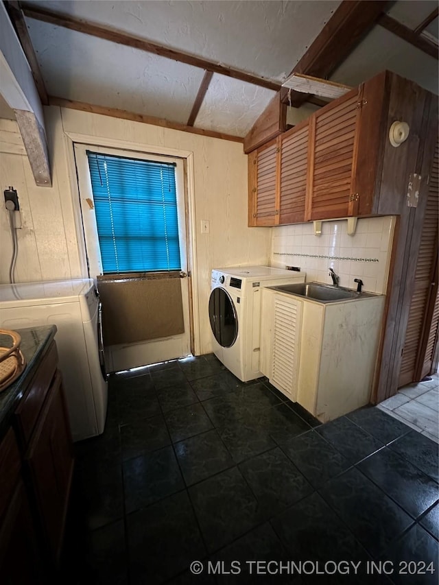 clothes washing area featuring electric dryer hookup, cabinets, and sink