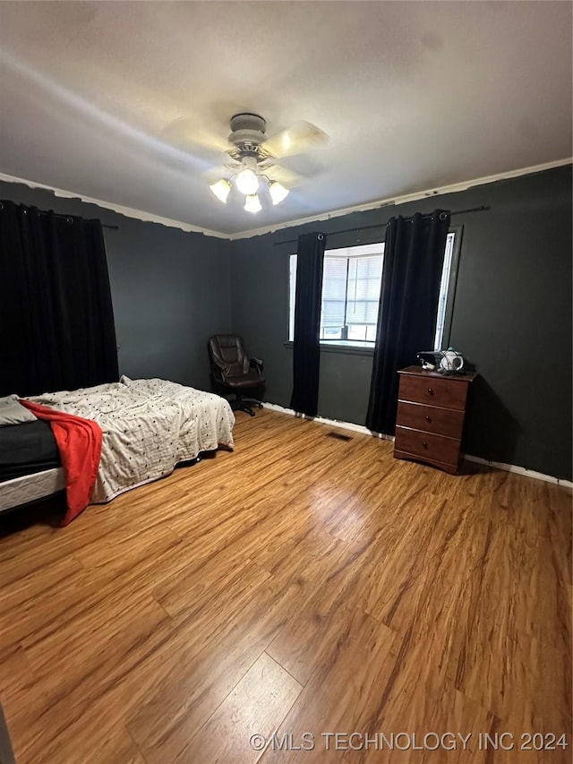 bedroom featuring light hardwood / wood-style flooring and ceiling fan