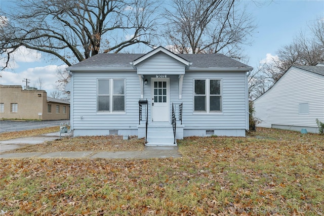 bungalow-style house with a front lawn