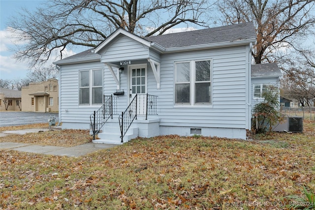 bungalow-style home with central AC unit