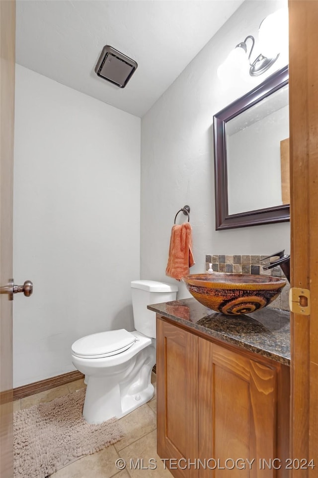 bathroom with tile patterned floors, vanity, and toilet