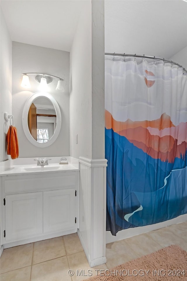 bathroom featuring a shower with curtain, vanity, and tile patterned floors