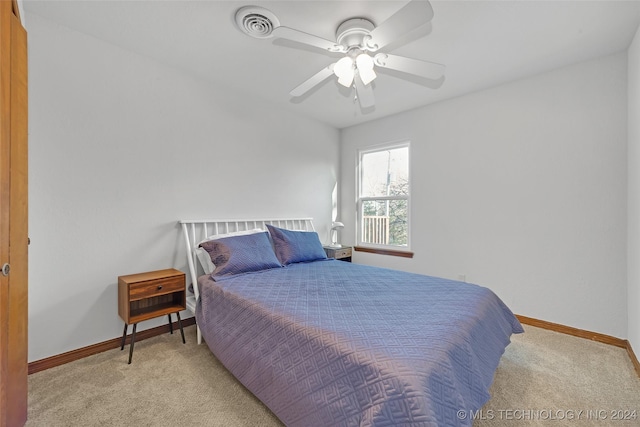 bedroom featuring ceiling fan and light carpet