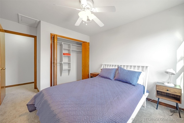 bedroom with ceiling fan, light colored carpet, and a closet