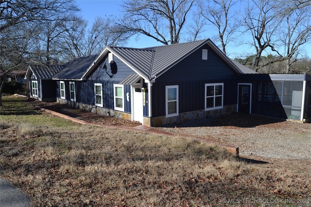 view of side of home with a sunroom