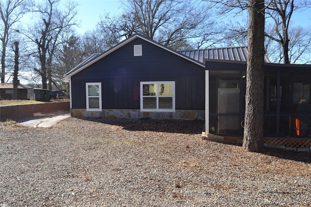 view of property exterior with a sunroom