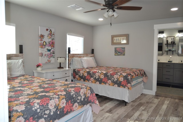 bedroom featuring connected bathroom, light hardwood / wood-style floors, and ceiling fan