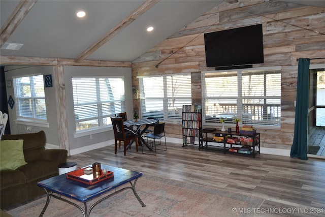 living room with lofted ceiling with beams and hardwood / wood-style flooring