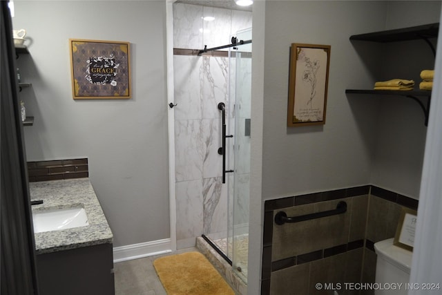 bathroom with vanity and a shower with shower door