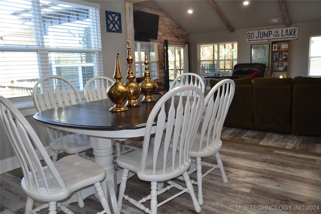 dining room featuring wood-type flooring and vaulted ceiling