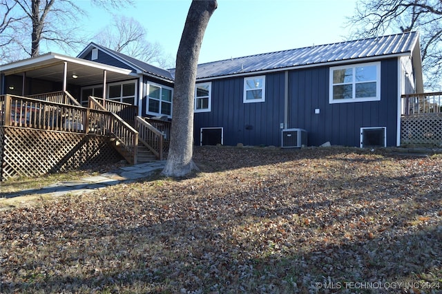 back of house with central AC and a wooden deck