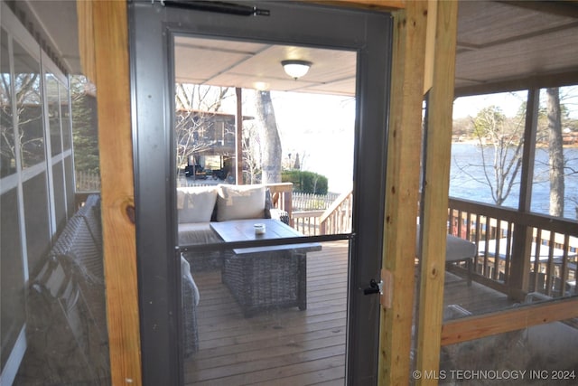 doorway with plenty of natural light and a water view