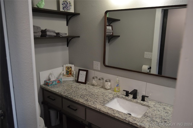 bathroom featuring decorative backsplash and vanity