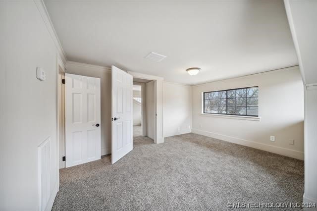 unfurnished bedroom with carpet flooring and ornamental molding