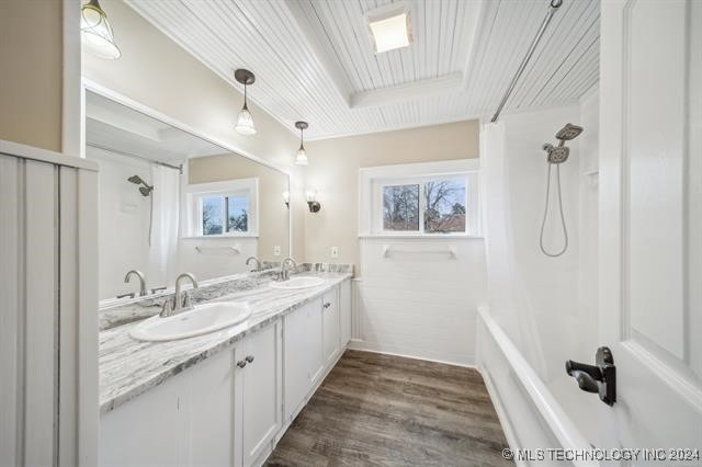 bathroom featuring a shower with curtain, vanity, wood-type flooring, and a wealth of natural light