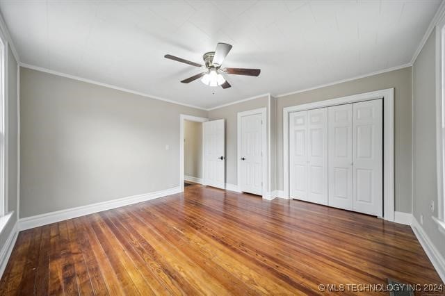 unfurnished bedroom with hardwood / wood-style floors, ceiling fan, and ornamental molding