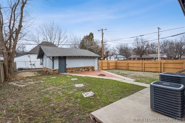 view of yard featuring central AC unit and a patio area