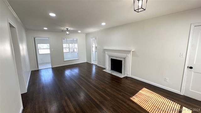 unfurnished living room with ceiling fan, dark wood-type flooring, and a high end fireplace