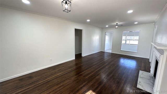 unfurnished living room featuring dark hardwood / wood-style flooring, ornamental molding, and a fireplace