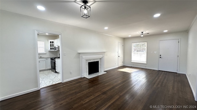 unfurnished living room with a fireplace and wood-type flooring