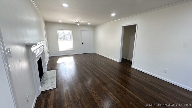 unfurnished living room featuring dark hardwood / wood-style flooring and ornamental molding