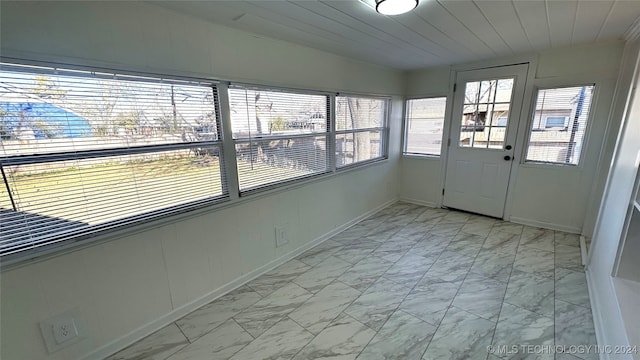 unfurnished sunroom with wooden ceiling