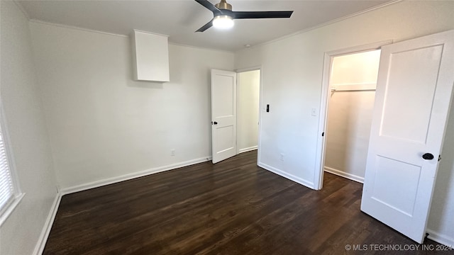 unfurnished bedroom featuring ceiling fan, ornamental molding, and dark wood-type flooring